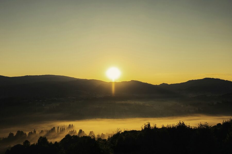 Morning light breaking over a mountain valley.